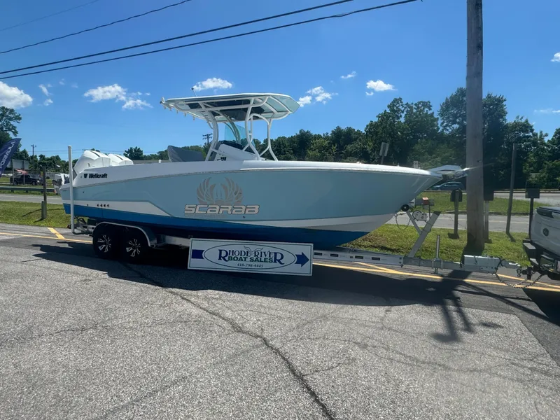 Slide: The Image of 2022 Wellcraft 262 Fisherman boat on trailer in parking lot. - 11