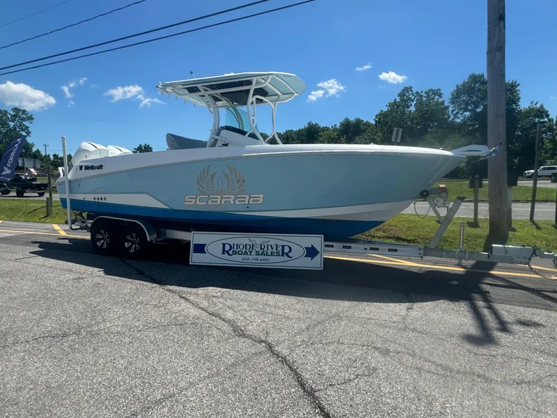 Slide: The Image of 2022 Wellcraft 262 Fisherman boat on trailer, displayed outdoors. - 12