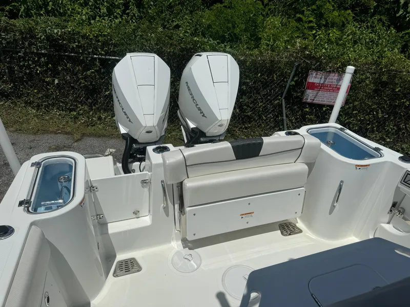 Slide: The Image of 2022 Wellcraft 262 Fisherman boat with twin outboard motors and seating area. - 13