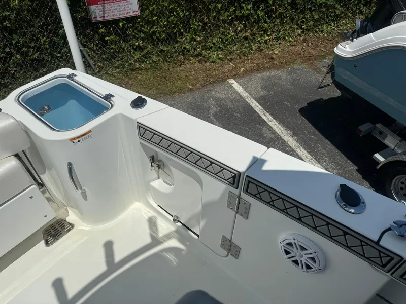 Slide: The Image of 2022 Wellcraft 262 Fisherman boat interior, featuring storage compartments and a livewell. - 14