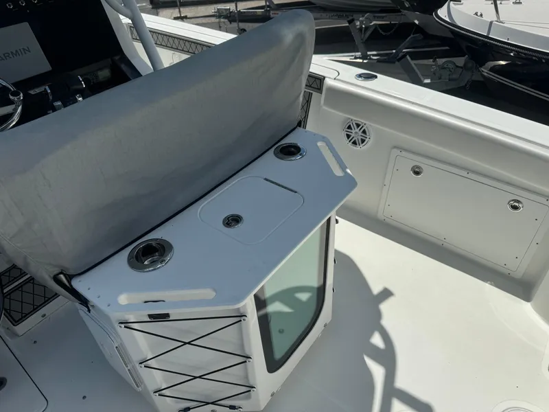 Slide: The Image of 2022 Wellcraft 262 Fisherman boat interior with covered seating and storage compartments. - 15