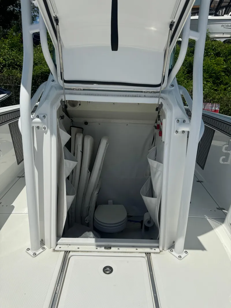 Slide: The Image of 2022 Wellcraft 262 Fisherman boat storage compartment with marine toilet. - 17