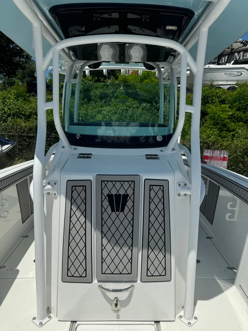 Slide: The Image of 2022 Wellcraft 262 Fisherman boat center console with T-top and storage compartments. - 18