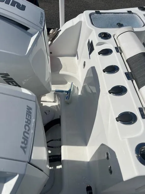 Slide: The Image of 2022 Wellcraft 262 Fisherman boat with Mercury engines and fishing rod holders. - 2