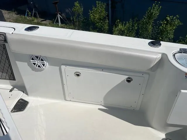 Slide: The Image of 2022 Wellcraft 262 Fisherman boat interior, featuring storage compartment and speaker. - 5