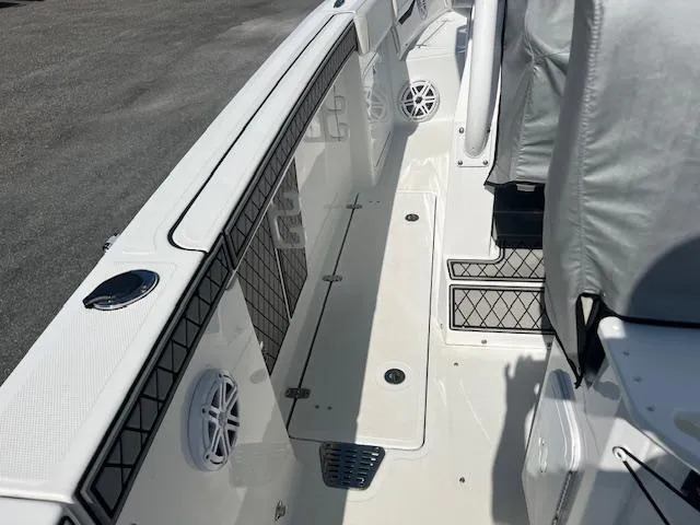 Slide: The Image of 2022 Wellcraft 262 Fisherman boat interior with storage compartments and speakers. - 6