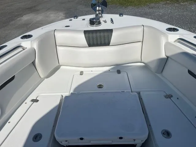 Slide: The Image of 2022 Wellcraft 262 Fisherman boat interior with cushioned seating and storage compartments. - 7
