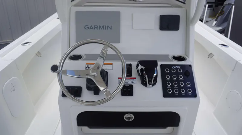 Slide: The Image of Parker 2400 CC 2025 boat console with Garmin navigation system and steering wheel. - 10