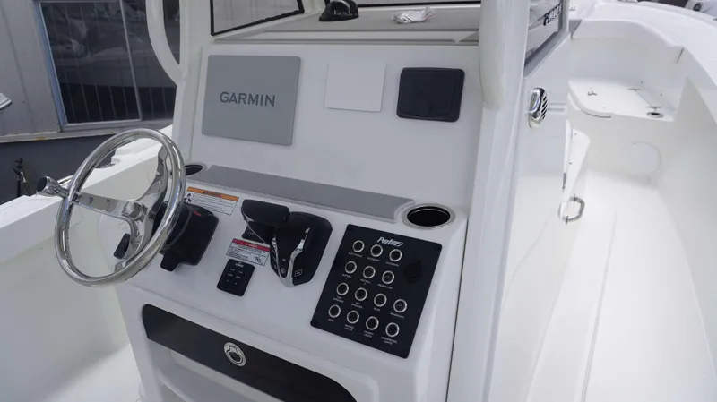 Slide: The Image of 2025 Parker 2400 CC boat console with Garmin navigation system and control panel. - 12