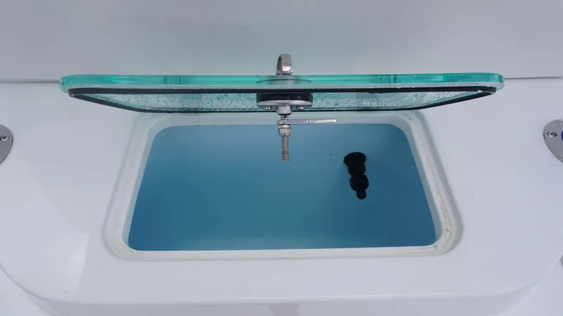 Slide: The Image of Open livewell compartment on a 2025 Parker 2400 CC boat. - 14