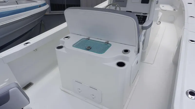 Slide: The Image of 2025 Parker 2400 CC boat interior with seating and storage compartments. - 2