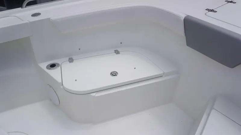 Slide: The Image of Interior of 2025 Parker 2400 CC boat, featuring storage compartment and seating area. - 5
