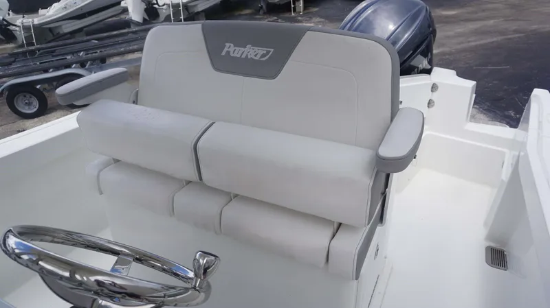 Slide: The Image of Captain's seat and steering wheel of a 2025 Parker 2400 CC boat. - 7