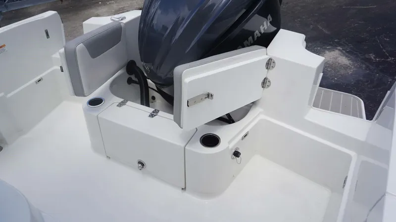 Slide: The Image of 2025 Parker 2400 CC boat with Yamaha engine and open storage compartments. - 8
