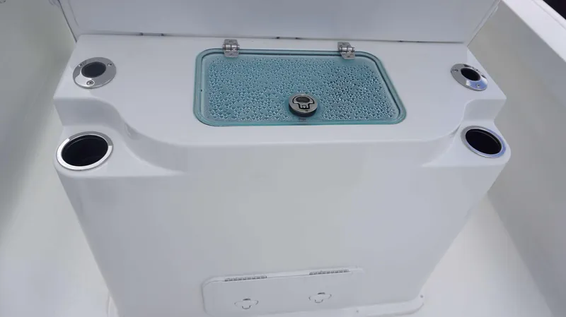 Slide: The Image of Parker 2400 CC 2025 boat livewell with cup holders and a transparent lid. - 9