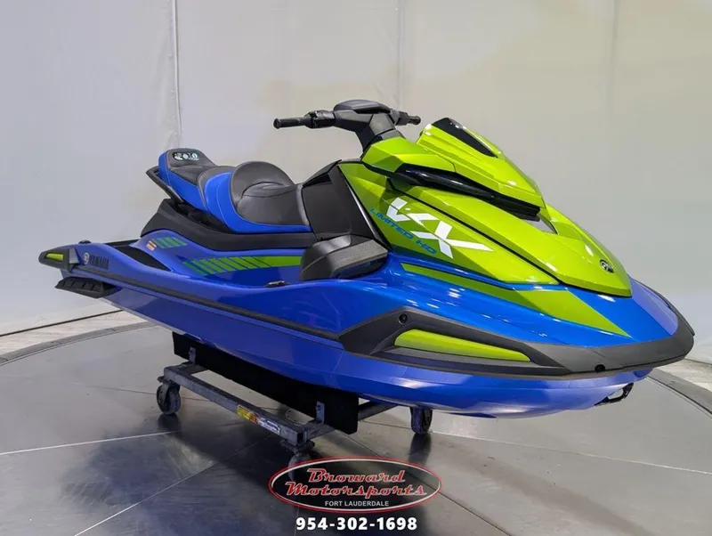 Slide: The Image of 2024 Yamaha VX® Limited HO jet ski in vibrant blue and green on display. - 0