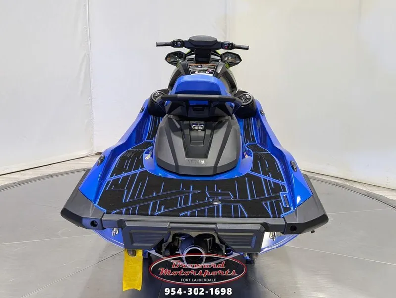 Slide: The Image of 2024 Yamaha Boats VX® Limited HO, blue jet ski, rear view, displayed indoors. - 6