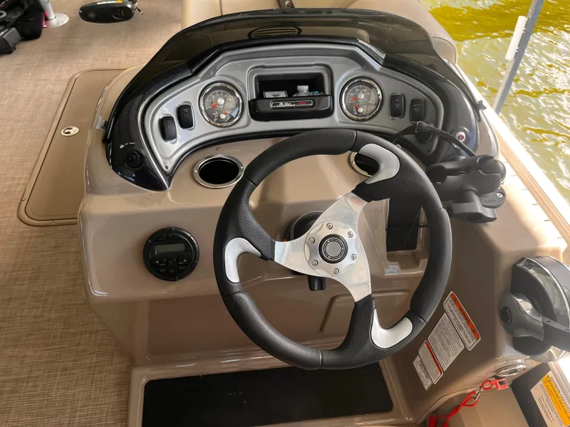 Slide: The Image of 2019 Sun Tracker Fishin' Barge 24 DLX steering console with gauges and controls. - 27