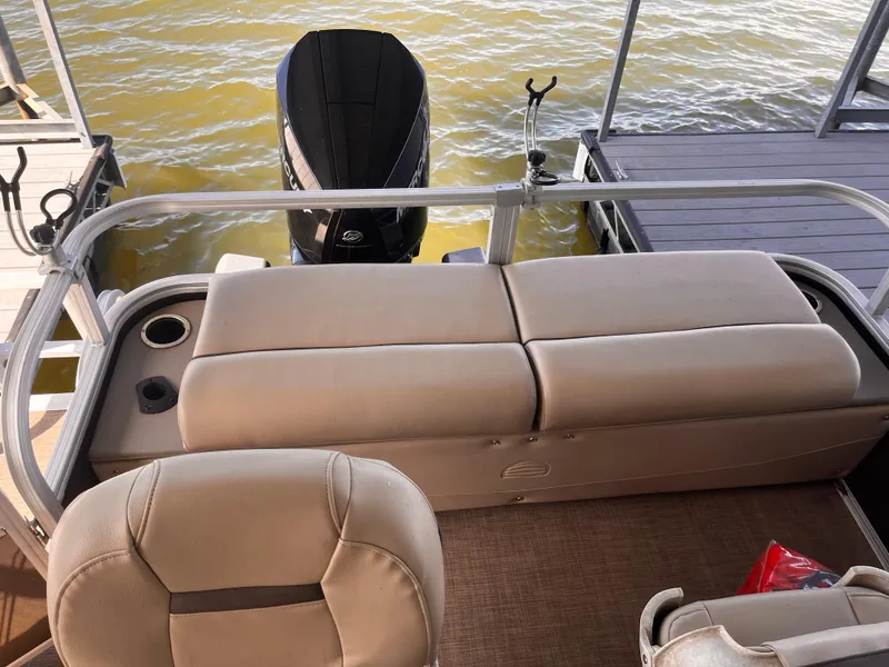 Slide: The Image of 2019 Sun Tracker Fishin' Barge 24 DLX pontoon boat with beige seating and outboard motor. - 35