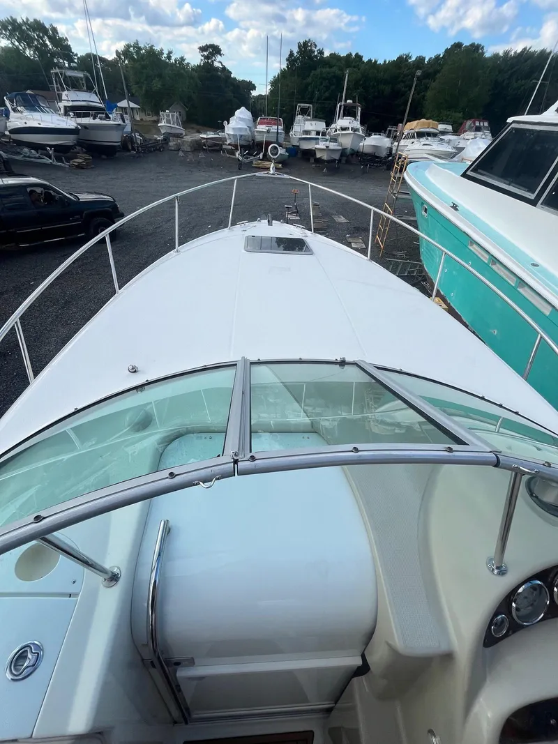 Slide: The Image of 2007 Chaparral Signature 280 boat docked in a marina with other boats. - 10