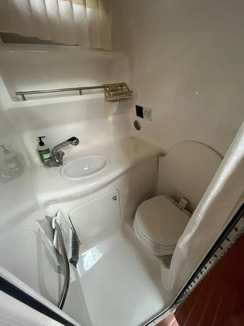 Slide: The Image of Compact bathroom in 2007 Chaparral Signature 280 boat with sink and toilet. - 12