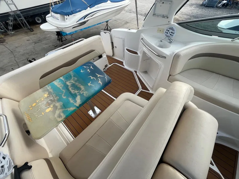 Slide: The Image of 2007 Chaparral Signature 280 boat interior with beige seating and custom table. - 6