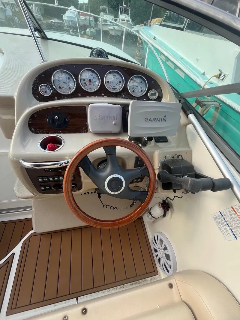 Slide: The Image of 2007 Chaparral Signature 280 boat helm with Garmin GPS and wood-trimmed steering wheel. - 8