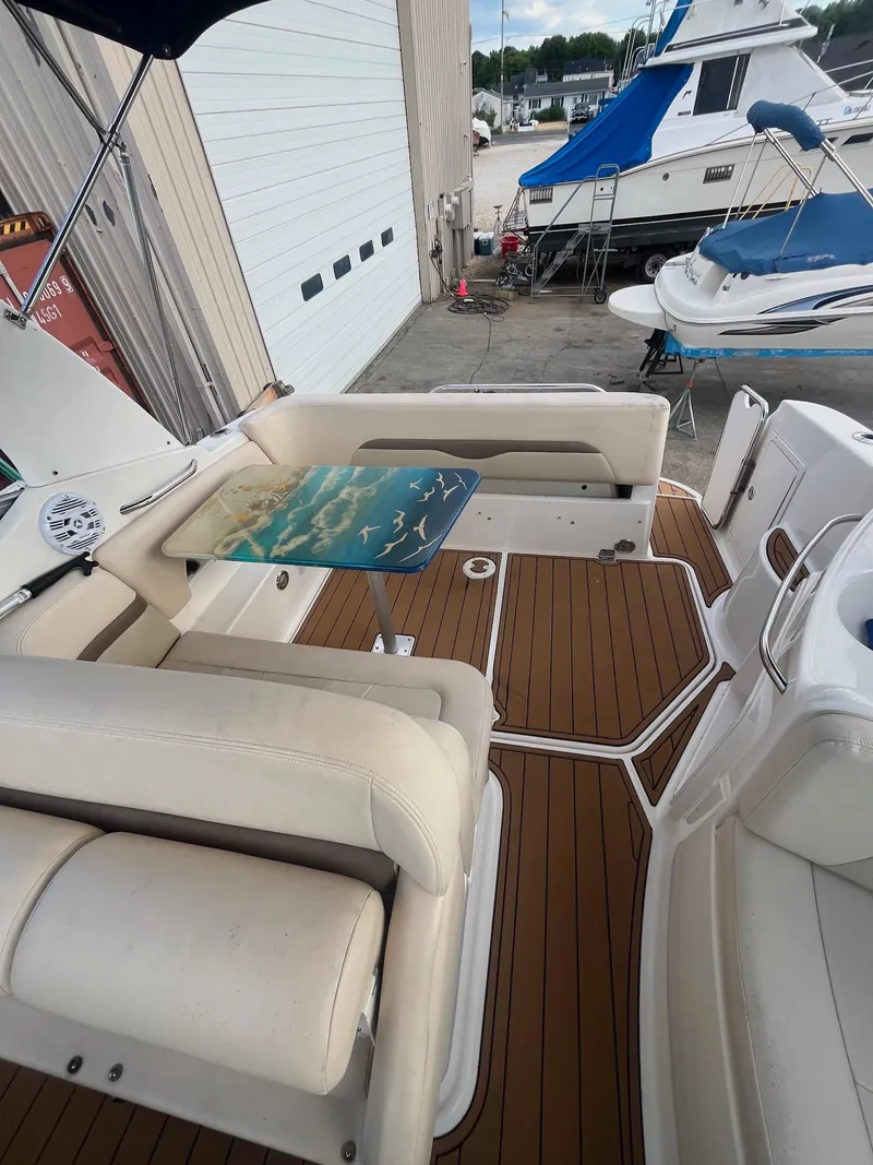 Slide: The Image of 2007 Chaparral Signature 280 boat interior with teak flooring and white seating. - 9