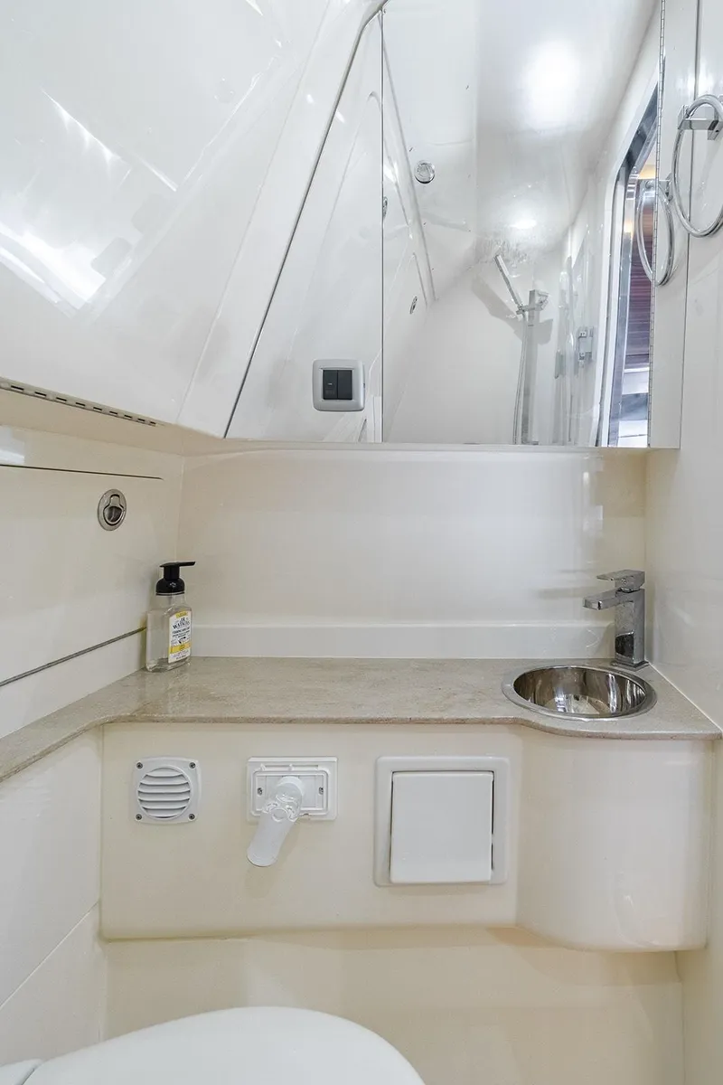 Slide: The Image of 2020 Scout 420 LXF boat bathroom with sink, mirror, and modern fixtures. - 12