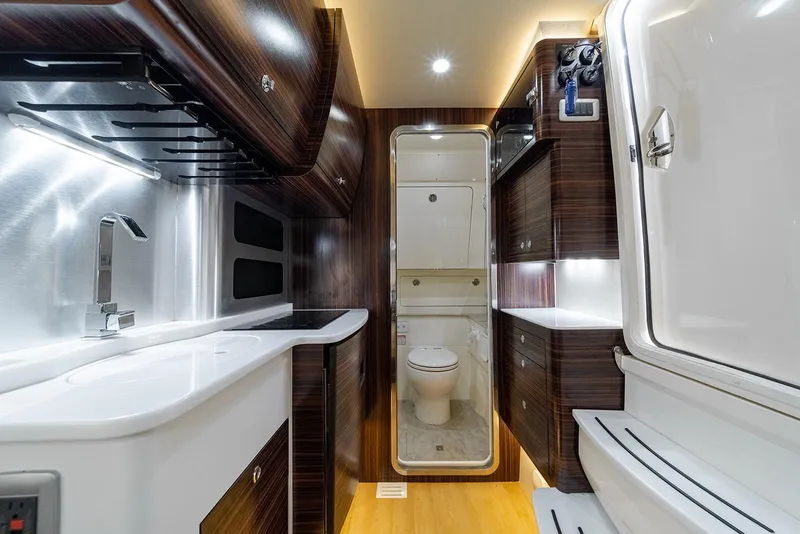 Slide: The Image of Luxurious interior of 2020 Scout 420 LXF boat featuring modern kitchen and bathroom. - 15