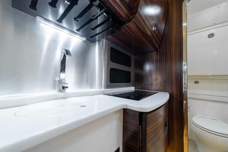 Slide: The Image of Luxurious interior of 2020 Scout 420 LXF boat featuring modern sink and cabinetry. - 17