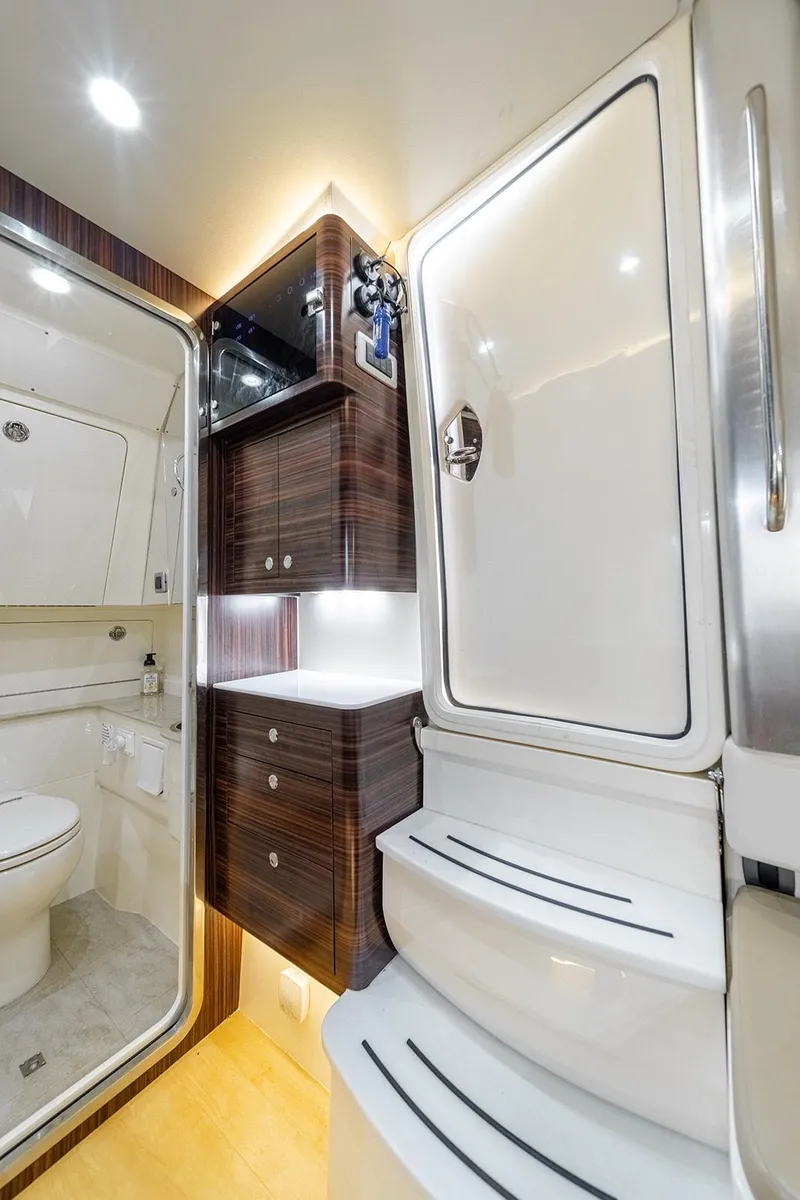 Slide: The Image of 2020 Scout 420 LXF yacht interior with modern bathroom and sleek cabinetry. - 18