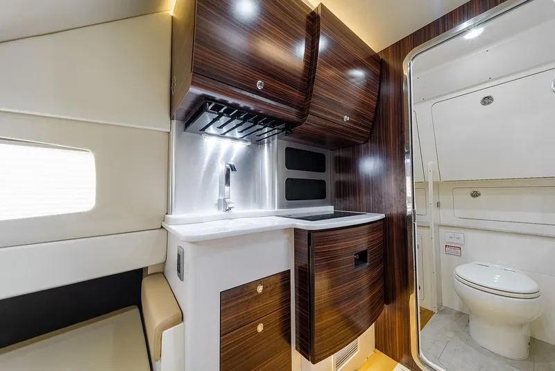 Slide: The Image of Luxurious interior of 2020 Scout 420 LXF yacht with modern kitchenette and bathroom. - 20