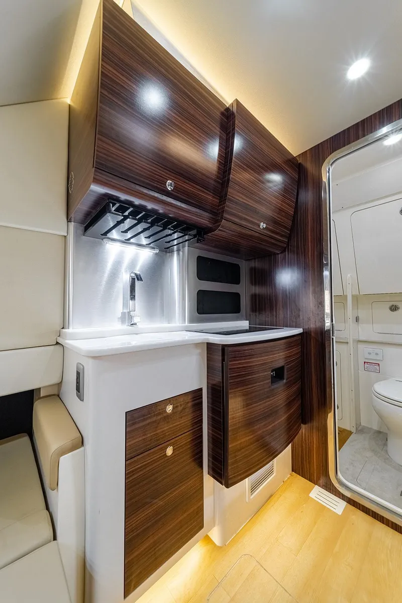 Slide: The Image of Luxurious interior of 2020 Scout 420 LXF boat with modern cabinetry and bathroom. - 21