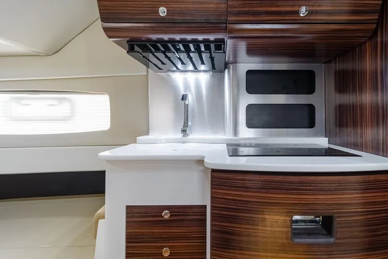 Slide: The Image of Modern kitchen interior of 2020 Scout 420 LXF boat with wood finish and sleek design. - 22