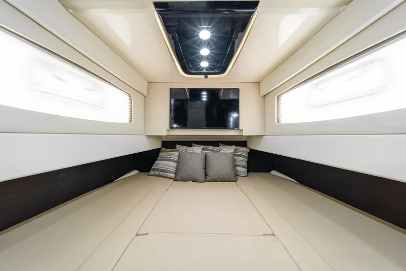 Slide: The Image of Luxurious interior cabin of 2020 Scout 420 LXF boat with TV and cushions. - 23