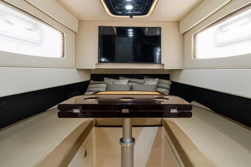 Slide: The Image of Interior of 2020 Scout 420 LXF yacht with seating, table, and TV. - 26