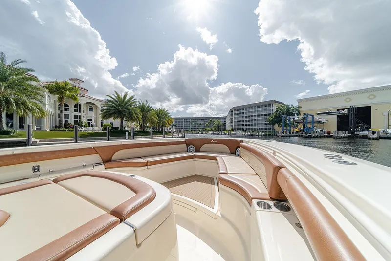 Slide: The Image of Luxurious 2020 Scout 420 LXF boat interior with waterfront view, palm trees, and sunny sky. - 32