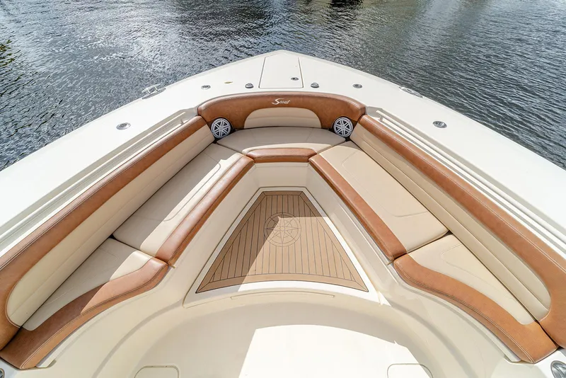 Slide: The Image of Luxurious seating area on 2020 Scout 420 LXF boat, featuring tan and cream upholstery. - 35