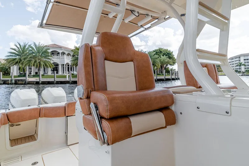 Slide: The Image of 2020 Scout 420 LXF boat interior with luxurious seating and waterfront view. - 46