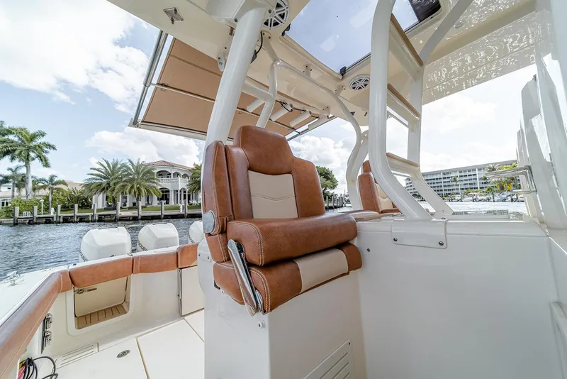 Slide: The Image of 2020 Scout 420 LXF boat interior with luxurious seating and waterfront view. - 47
