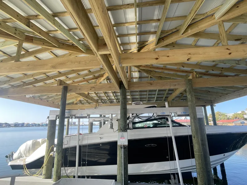 Slide: The Image of 2022 Sea Ray SLX 400 boat docked under wooden shelter. - 1