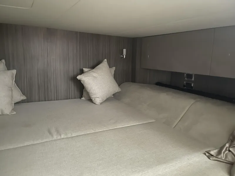 Slide: The Image of 2022 Sea Ray SLX 400 cabin interior with cozy bedding and modern design. - 11