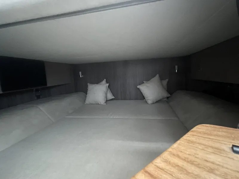 Slide: The Image of Luxurious cabin interior of 2022 Sea Ray SLX 400 with cozy bedding and pillows. - 12