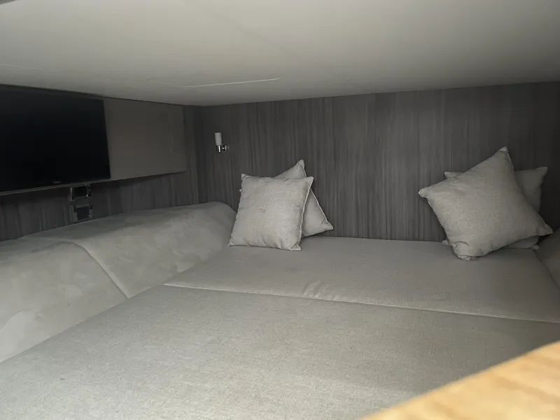 Slide: The Image of Interior cabin of 2022 Sea Ray SLX 400 with cozy bedding and pillows. - 13