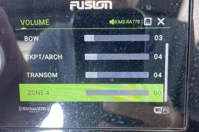 Slide: The Image of Fusion audio control panel on 2022 Sea Ray SLX 400 boat, displaying volume levels. - 16