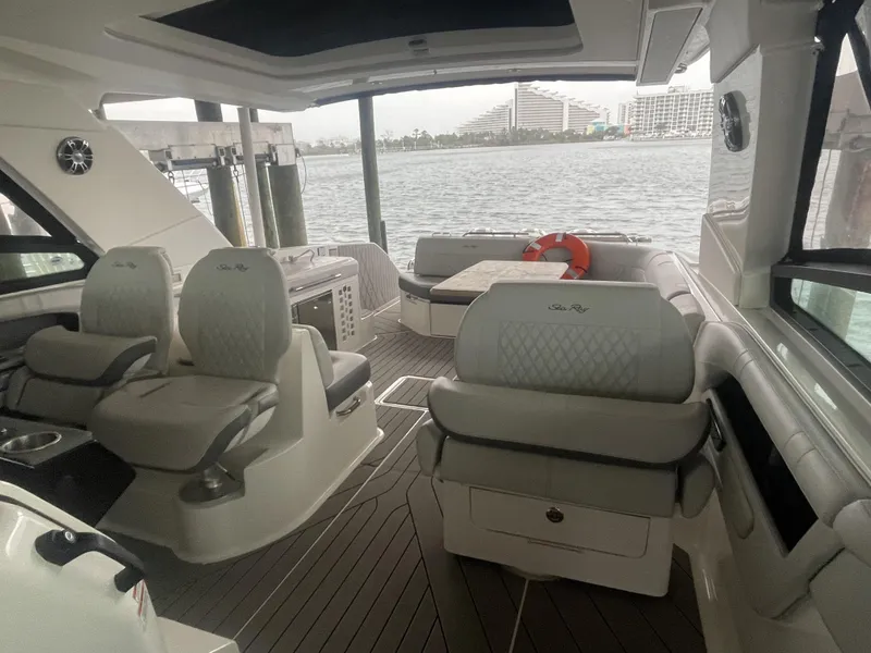 Slide: The Image of Interior of 2022 Sea Ray SLX 400 yacht with luxurious seating and waterfront view. - 2