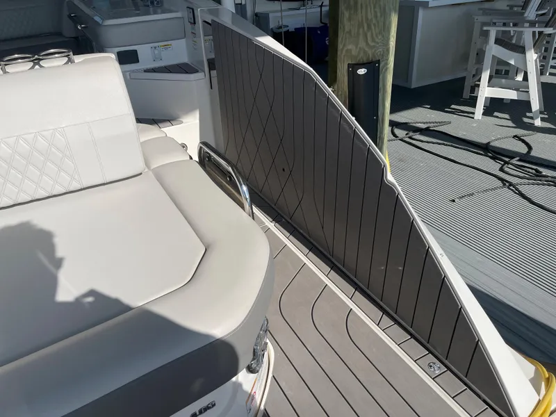Slide: The Image of 2022 Sea Ray SLX 400 boat interior with cushioned seating and sleek deck design. - 24