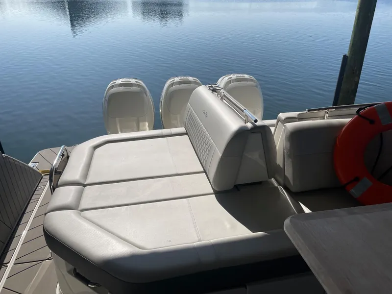 Slide: The Image of 2022 Sea Ray SLX 400 boat with spacious seating and triple outboard engines. - 25
