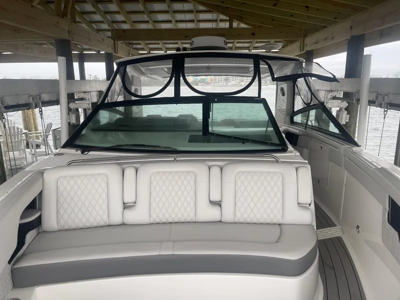 Slide: The Image of 2022 Sea Ray SLX 400 boat with luxurious seating under a covered dock. - 3